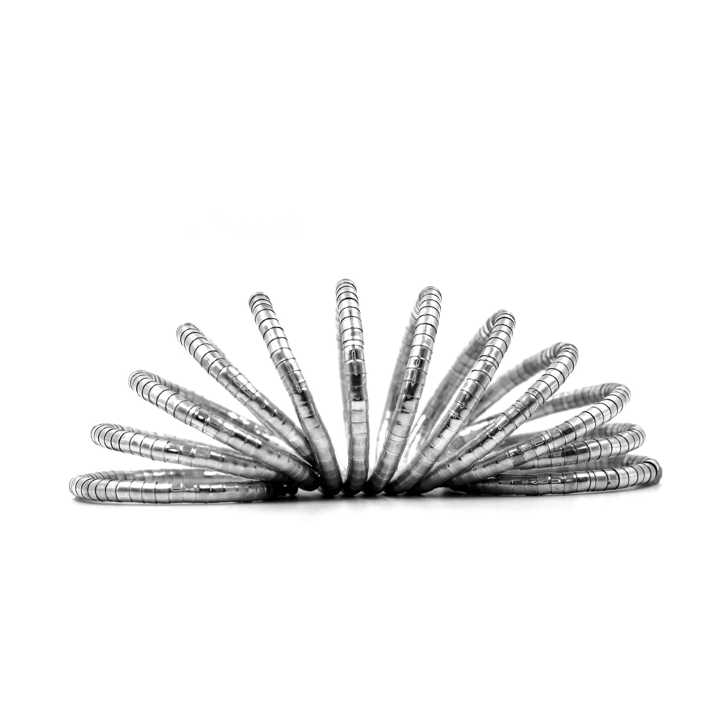 DIVAMAS Silver coil-style spring bangles stacked in side view, contemporary jewelry design for women._05
