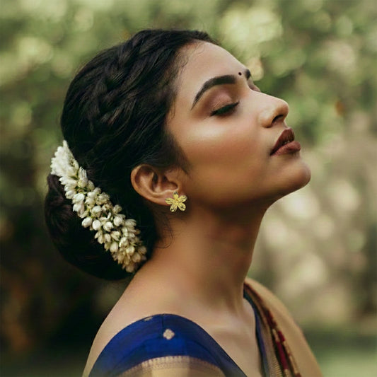 Lightweight gold-color floral stud earrings close-up