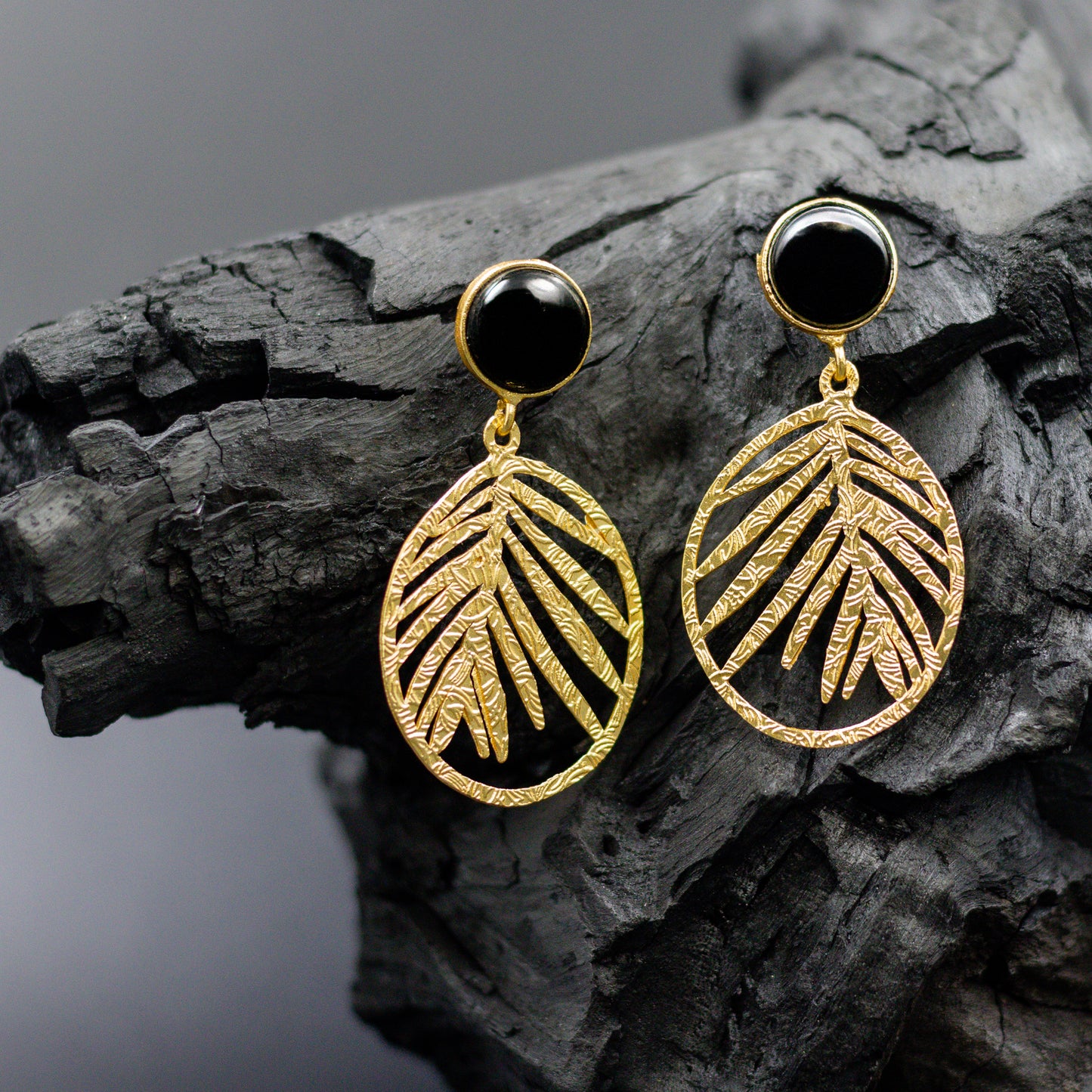 DIVAMAS gold leaf dangle earrings with black Monalisa stone stud – chic and versatile accessory for everyday and festive wear._02

