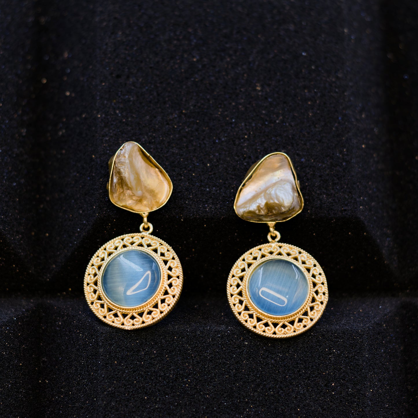 DIVAMAS statement earrings featuring aqua blue Monalisa stone and a raw Mother of Pearl stud top