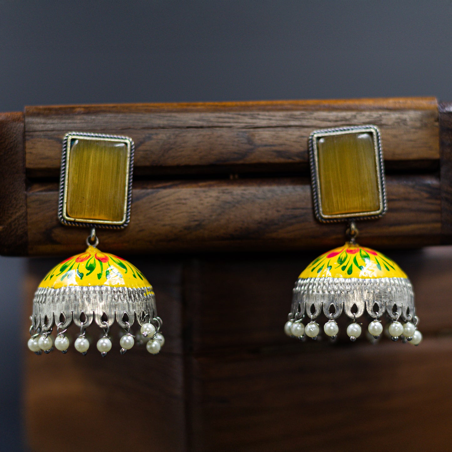DIVAMAS yellow Meenakari jhumka earrings with floral enamel, antique silver dome, and pearl tassels_01

