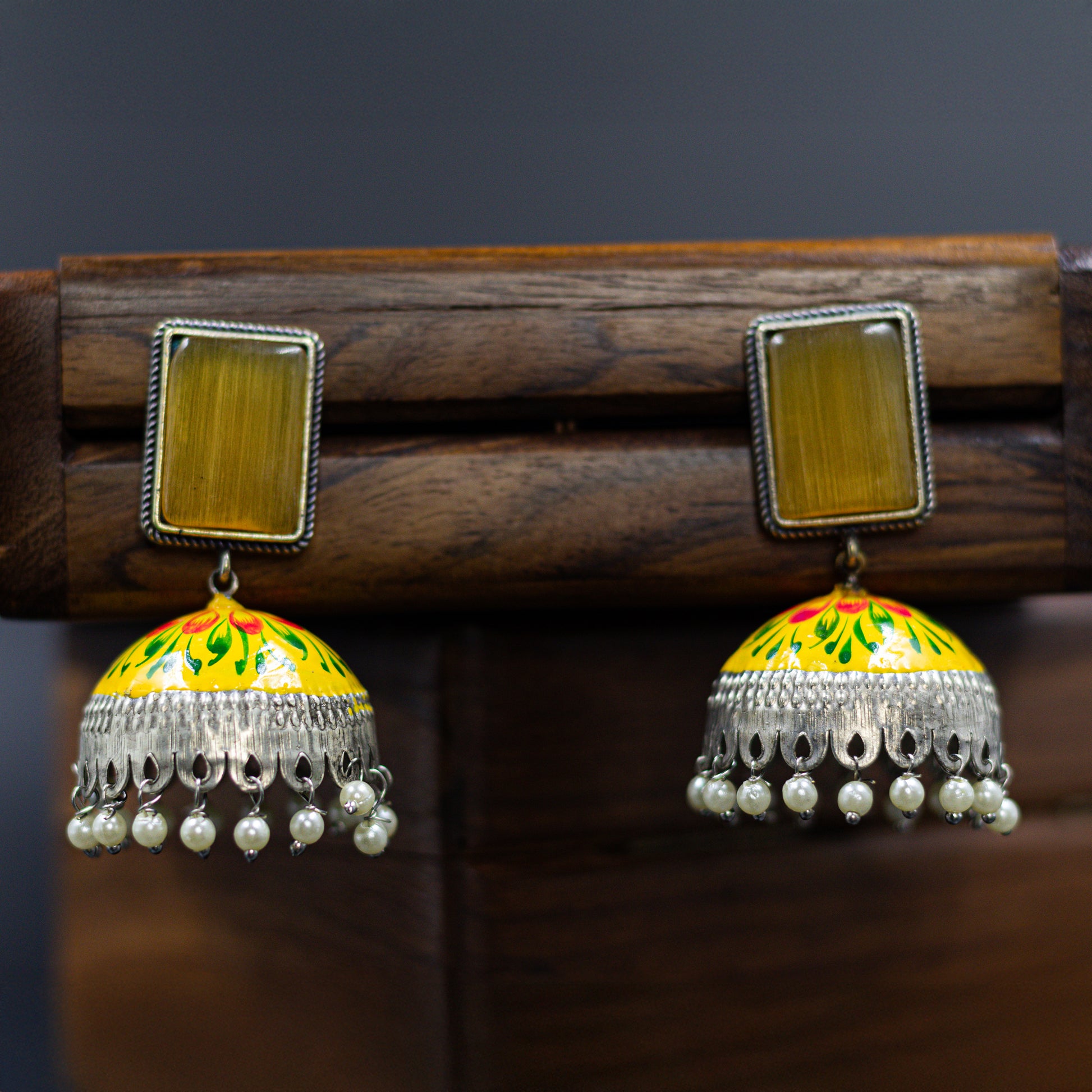 DIVAMAS yellow Meenakari jhumka earrings with floral enamel, antique silver dome, and pearl tassels_01

