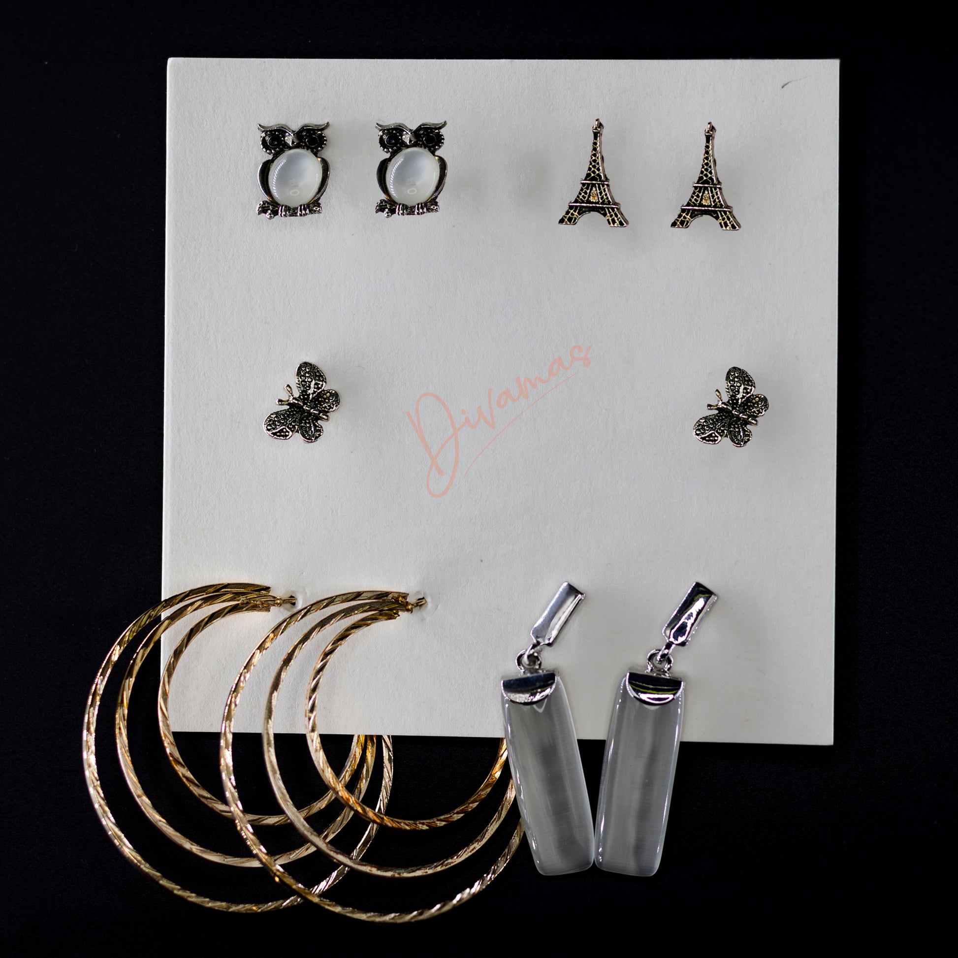 DIVAMAS Women’s Earring Combo featuring Owl Set, Eiffel Tower Set, Butterfly Set, Layered Hoop Set, and Crystal Set; stylish and versatile designs for all occasions_02


