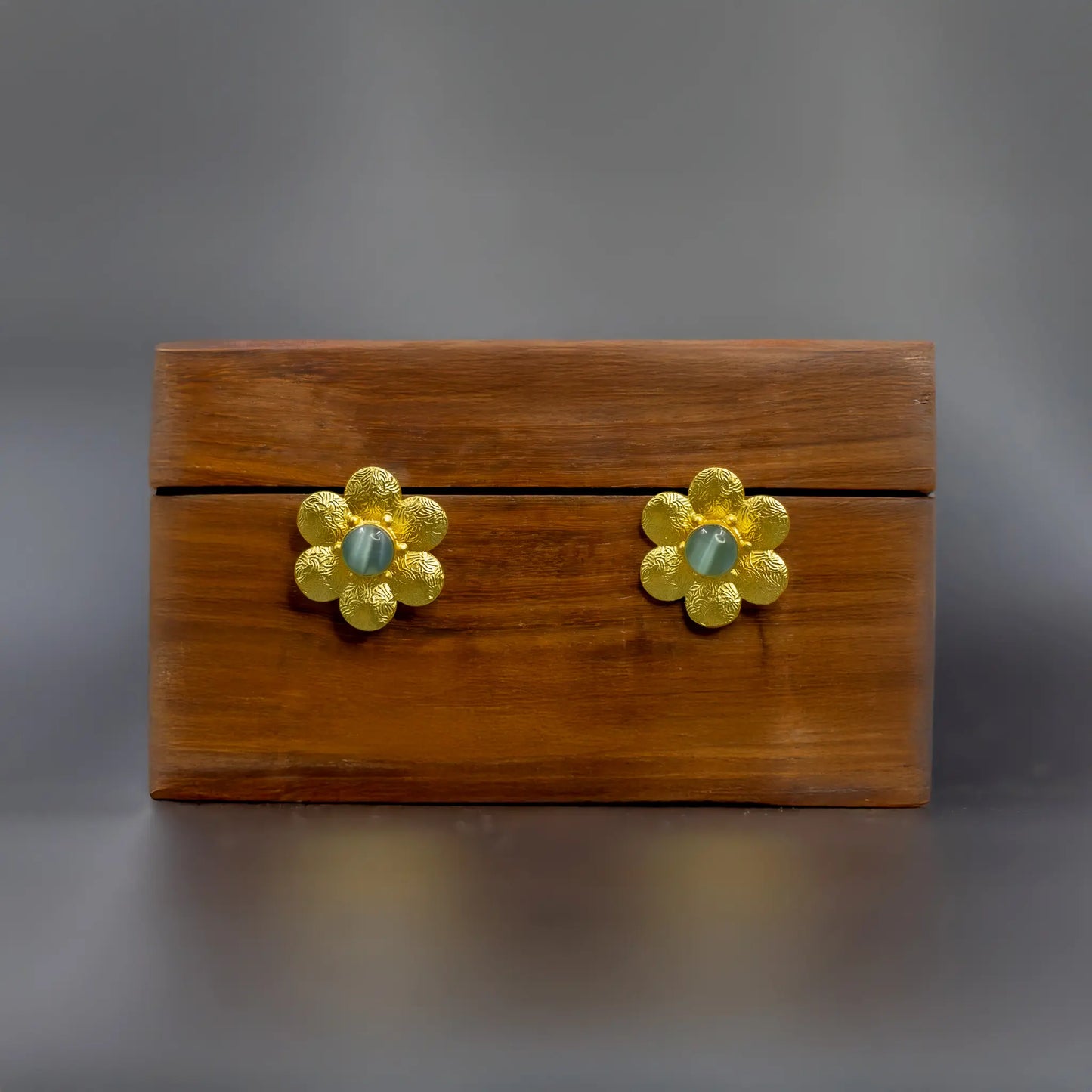 Divamas Elegant Floral Stud Earrings with Textured Gold Finish & Center Gem –Aqua Blue