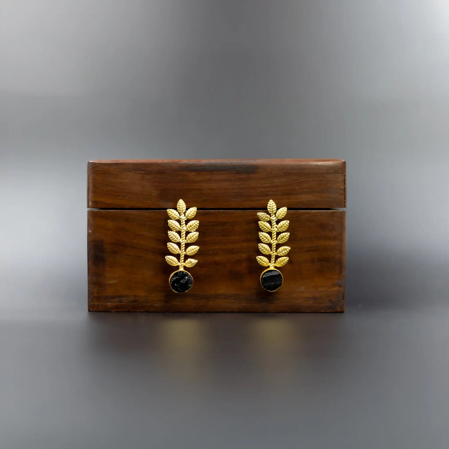 Divamas Gold Leaf Earrings with Black Stone – Bold & Luxe