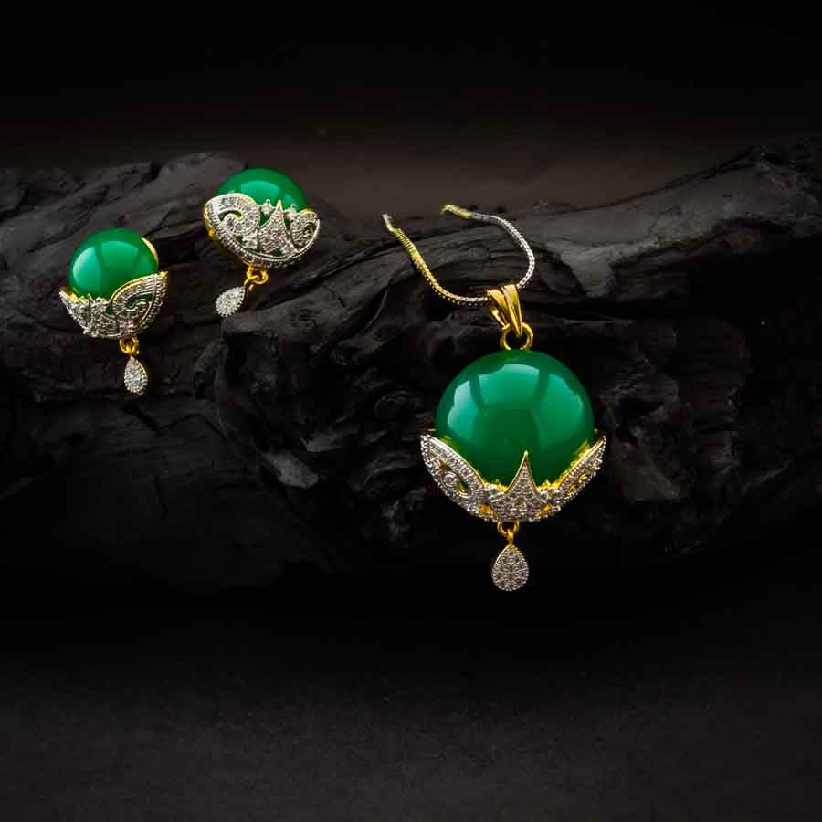 Elegant AD green round pendant set with sparkling American diamonds and a vibrant green centerpiece includes a pendant and matching earrings, perfect for parties and festive occasions.