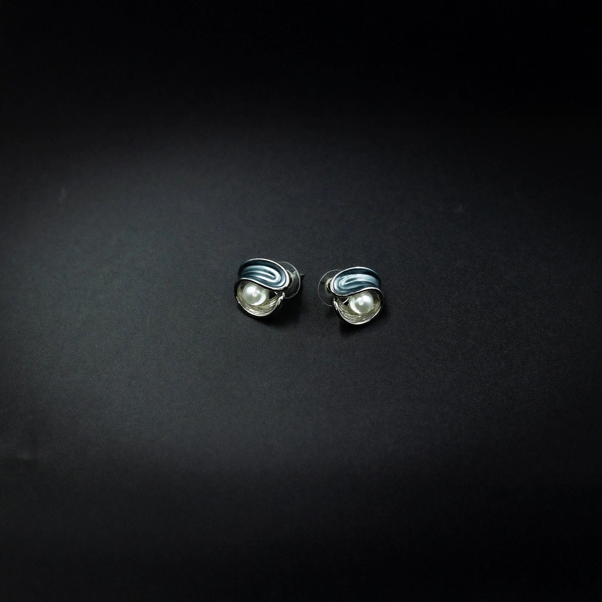 Elegant pearl detail swirl stud earrings
