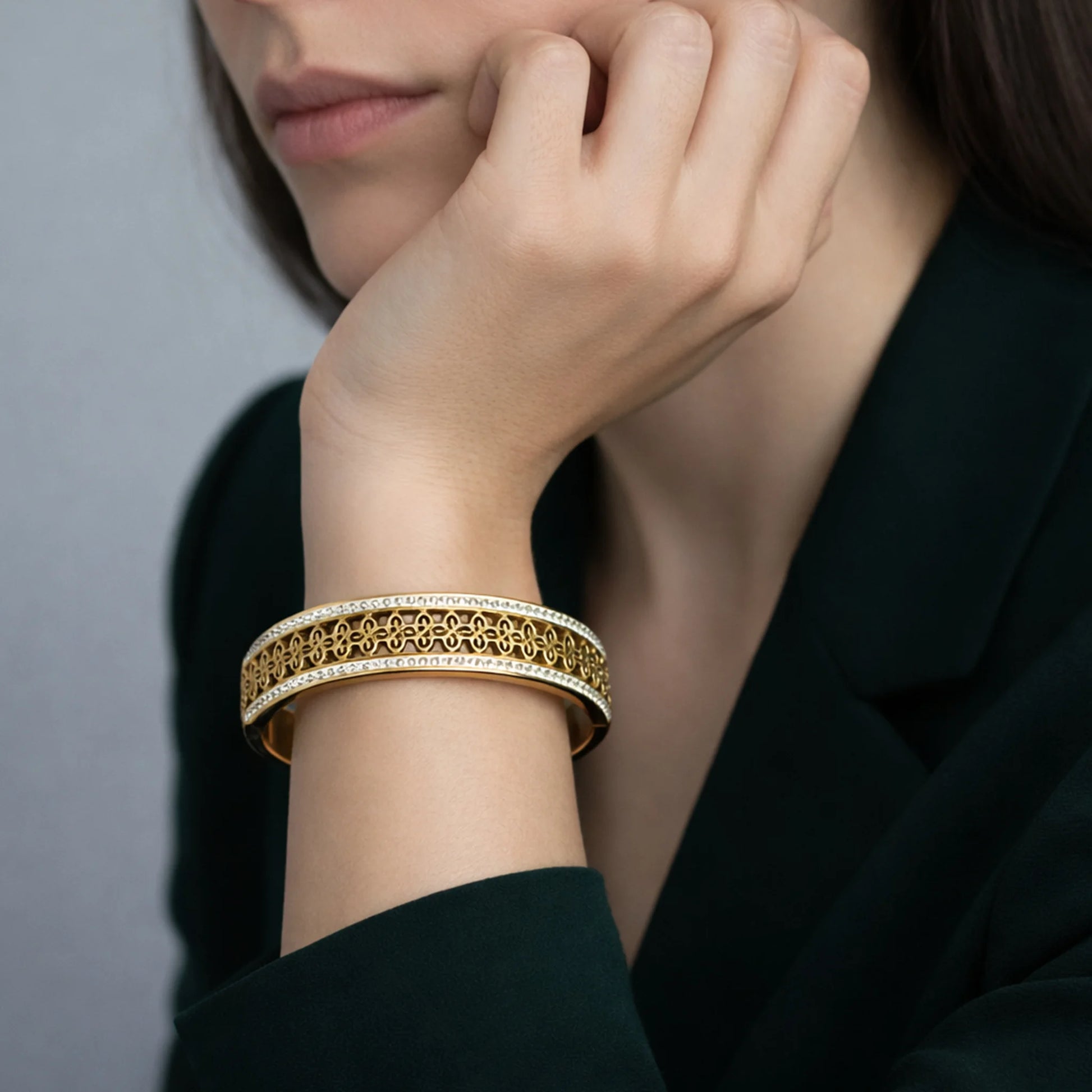 Gold finish filigree design bracelet with crystal border