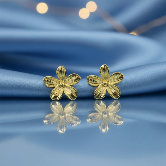 Minimal anti-tarnish gold floral earrings on dark background