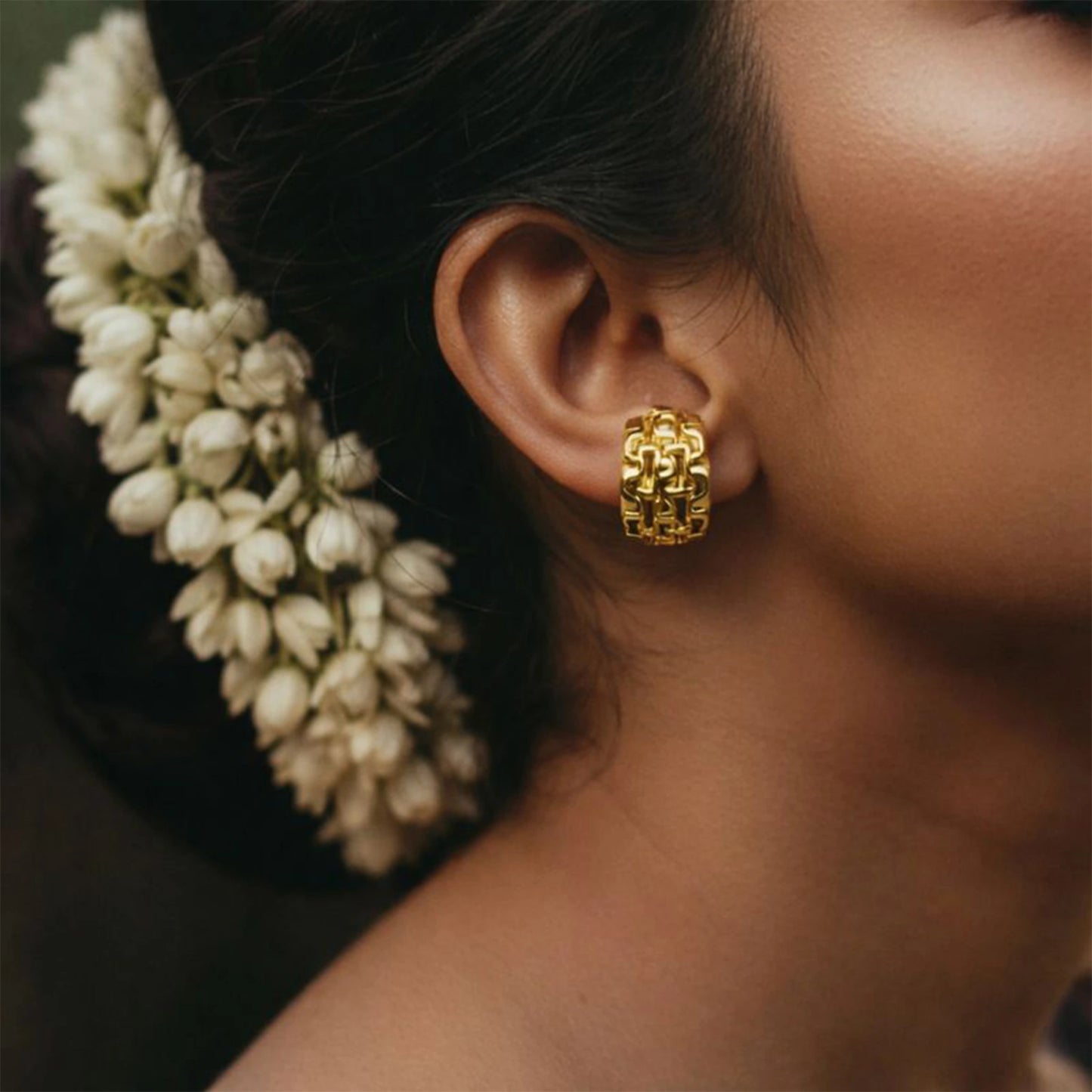 Modern anti-tarnish gold stud earrings on white background